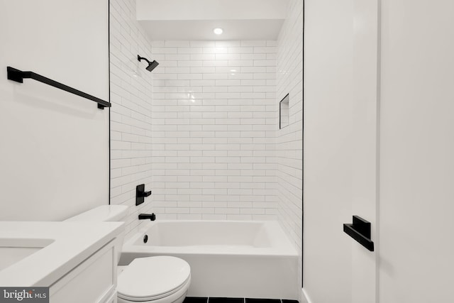 full bathroom featuring toilet, tiled shower / bath combo, and vanity