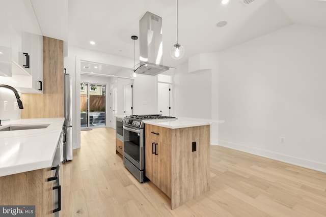 kitchen featuring island exhaust hood, appliances with stainless steel finishes, sink, and white cabinetry