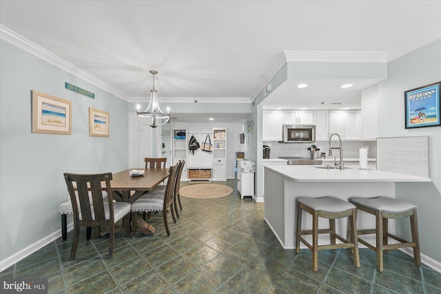 kitchen featuring white cabinetry, tasteful backsplash, sink, hanging light fixtures, and kitchen peninsula