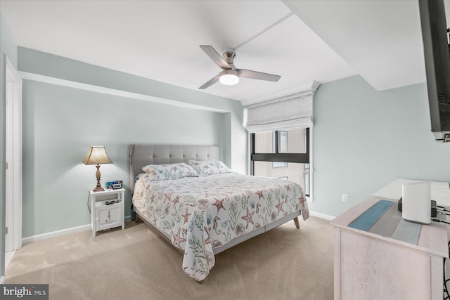 bedroom with ceiling fan and light carpet