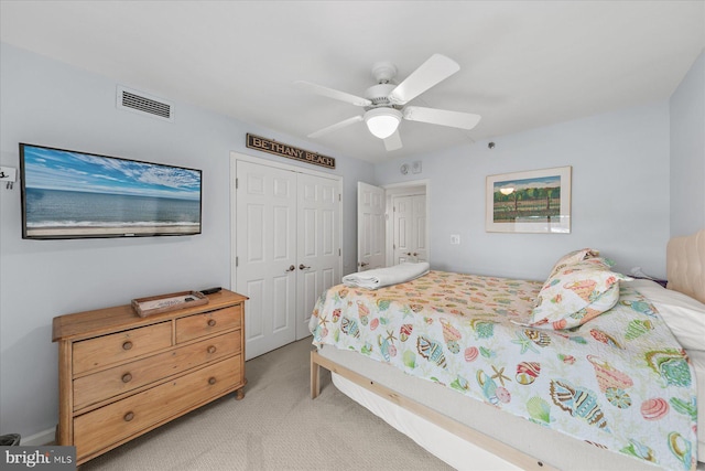 bedroom featuring a closet, ceiling fan, and light colored carpet