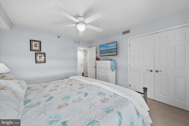 carpeted bedroom with ceiling fan and a closet