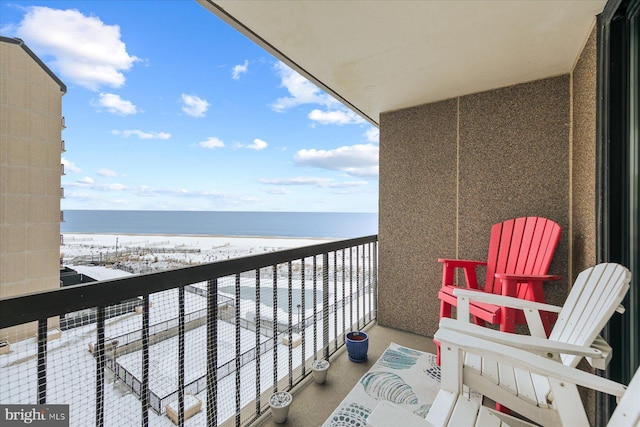 balcony featuring a water view and a view of the beach