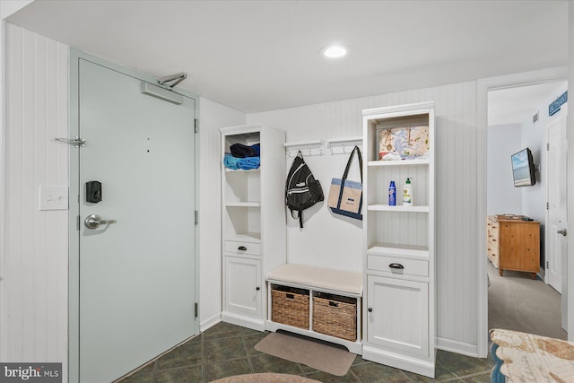 mudroom featuring wood walls