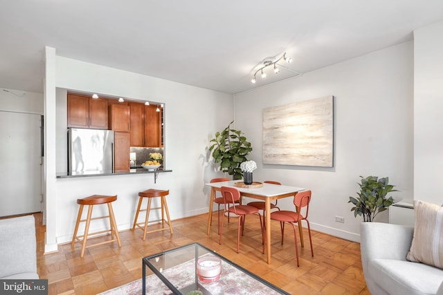 dining room featuring light parquet floors