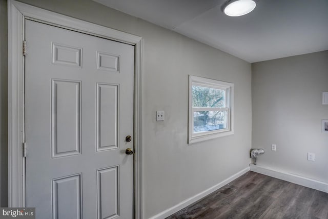 clothes washing area with dark hardwood / wood-style flooring