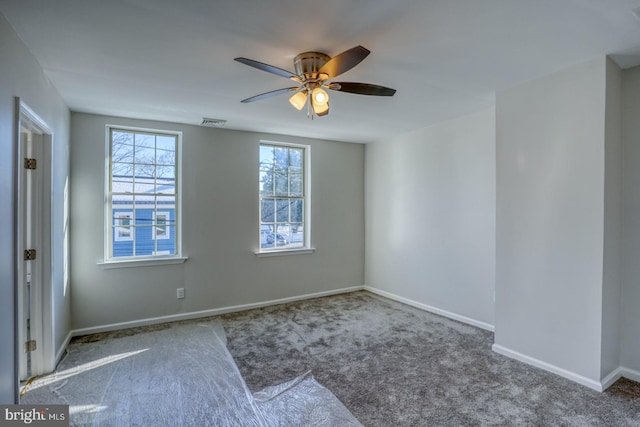 carpeted empty room featuring ceiling fan