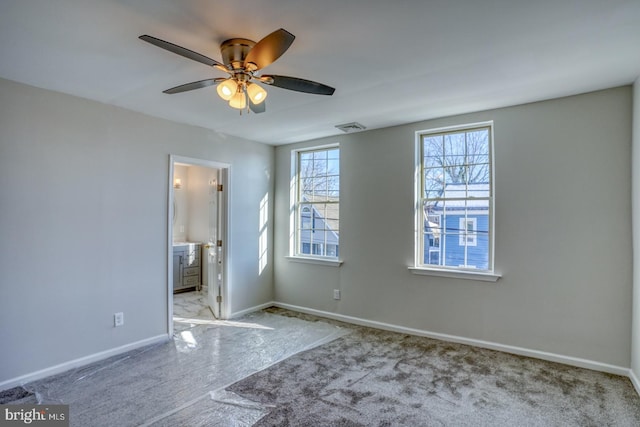 unfurnished bedroom featuring ceiling fan, connected bathroom, and light colored carpet