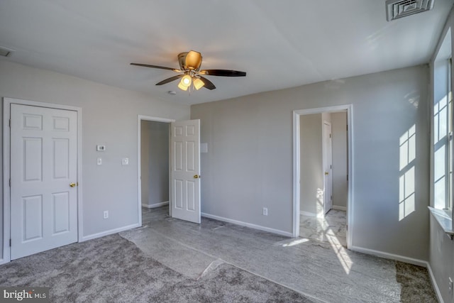 unfurnished bedroom with ceiling fan and light colored carpet