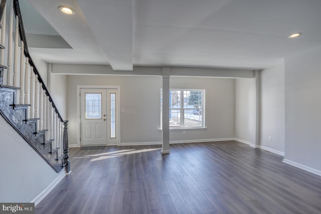 entryway with dark hardwood / wood-style flooring and beamed ceiling