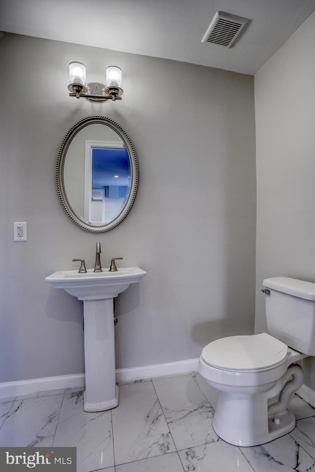 bathroom with toilet and sink