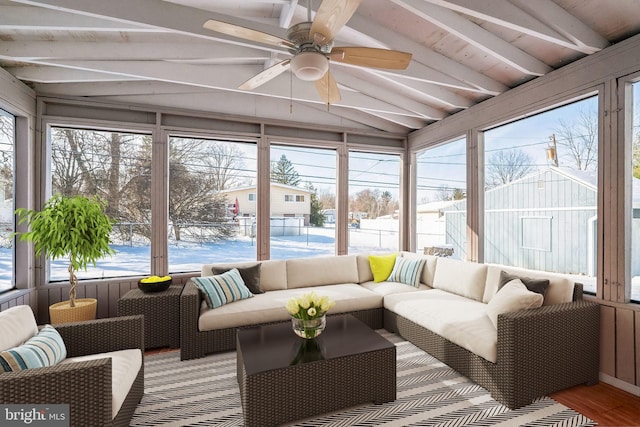 sunroom featuring ceiling fan and lofted ceiling with beams