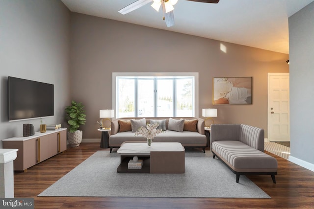 living room with ceiling fan, dark hardwood / wood-style floors, and vaulted ceiling