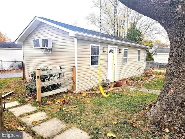 back of house with a lawn