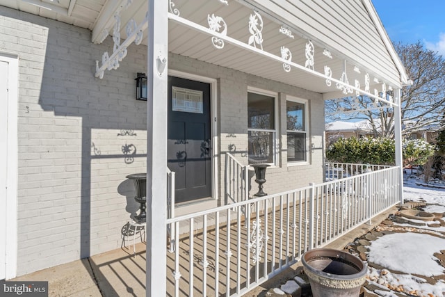 view of exterior entry featuring covered porch