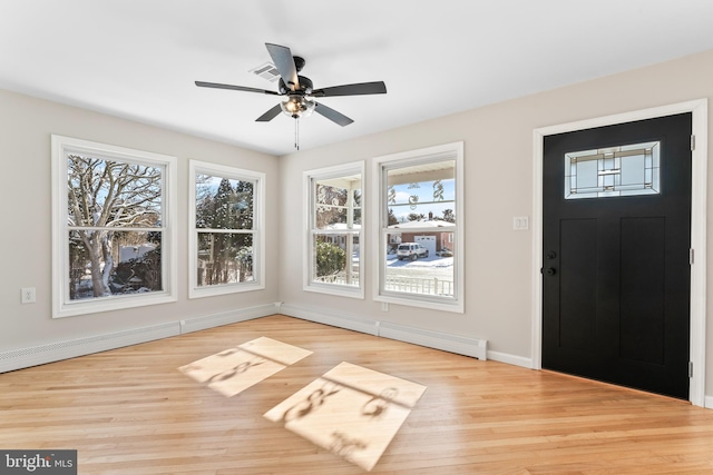 foyer entrance featuring ceiling fan, light wood-type flooring, and a wealth of natural light