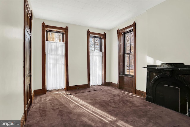 entryway with dark colored carpet