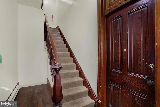 stairway featuring a baseboard radiator