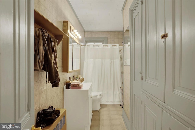 bathroom featuring tile walls, toilet, and walk in shower