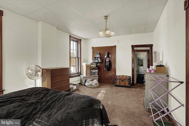 bedroom featuring an inviting chandelier and carpet