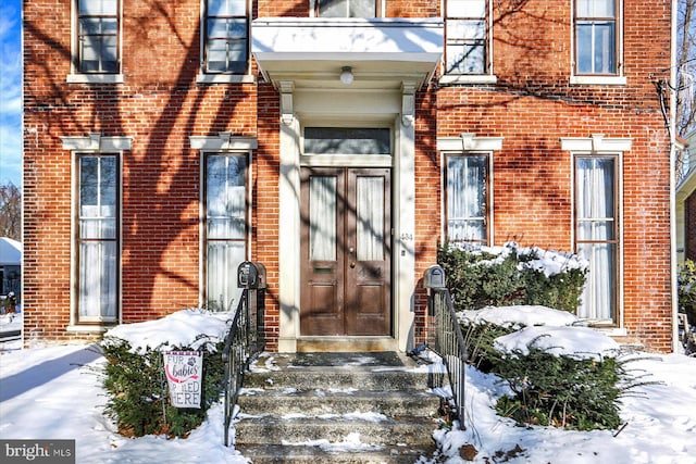 view of snow covered property entrance