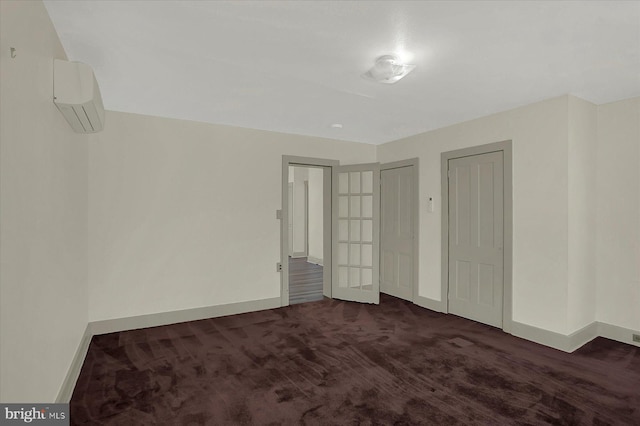 interior space featuring dark colored carpet and a wall unit AC