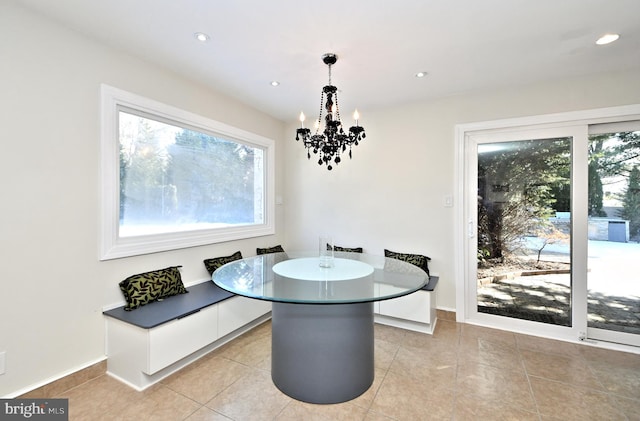 tiled dining room with breakfast area and an inviting chandelier