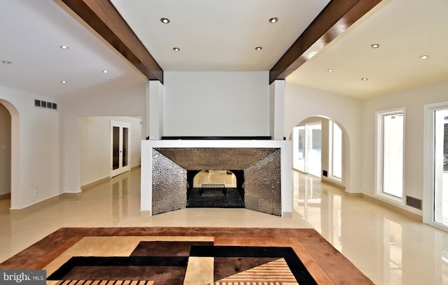 unfurnished living room featuring beamed ceiling