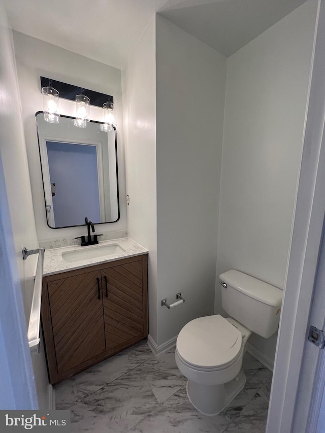 bathroom featuring toilet and vanity