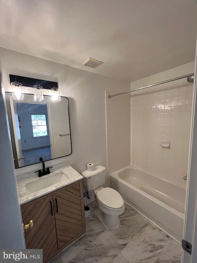 full bathroom featuring toilet, tiled shower / bath, and vanity