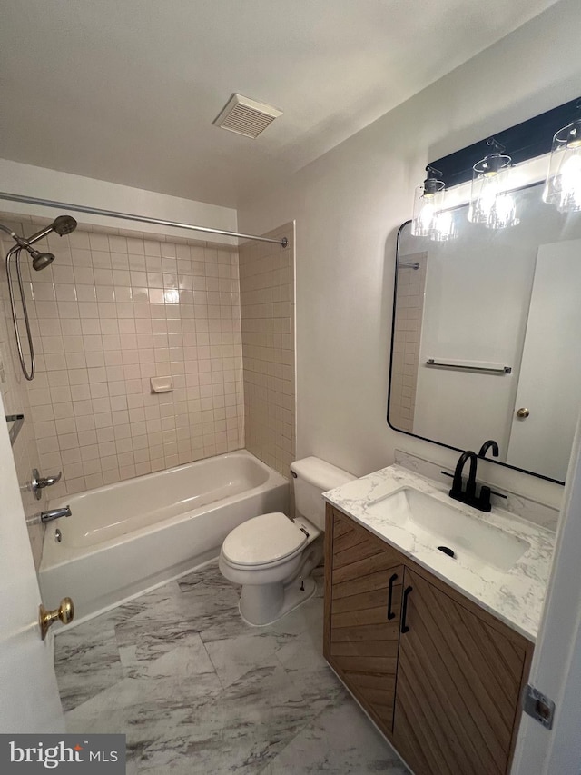 full bathroom featuring toilet, tiled shower / bath combo, and vanity