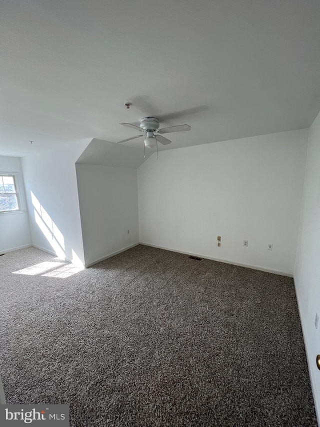 additional living space featuring ceiling fan, lofted ceiling, and carpet floors