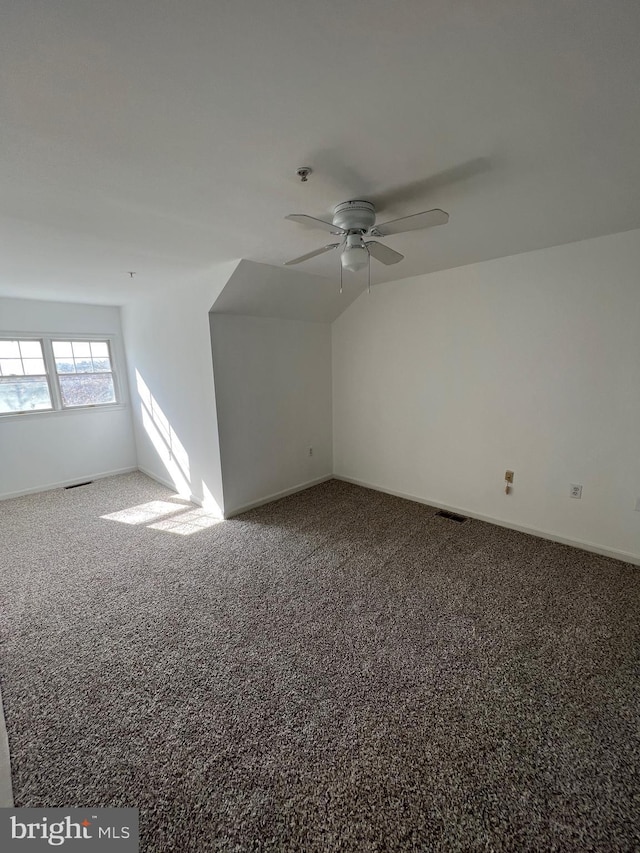 additional living space with ceiling fan, vaulted ceiling, and carpet flooring