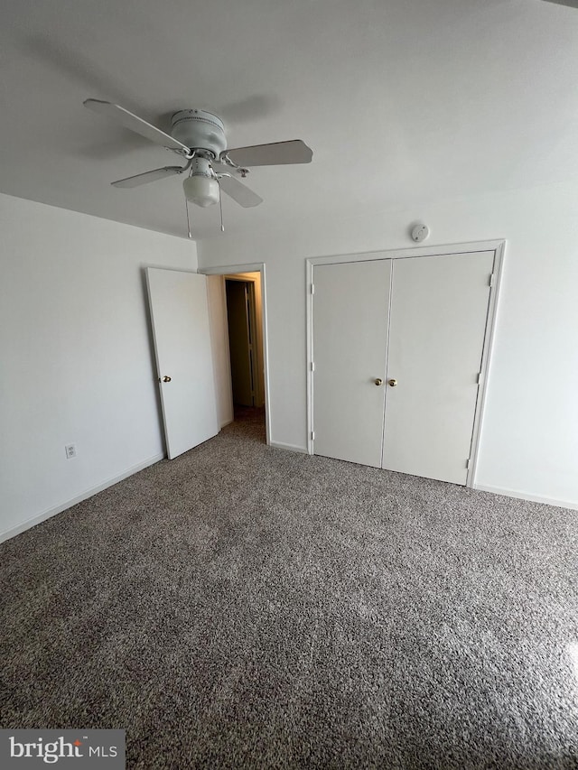 unfurnished bedroom featuring ceiling fan, a closet, and carpet floors