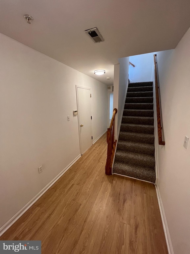 stairway featuring hardwood / wood-style floors