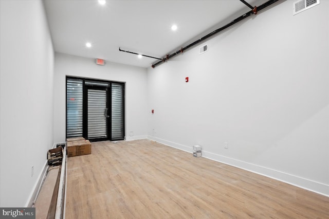 unfurnished room featuring light hardwood / wood-style floors