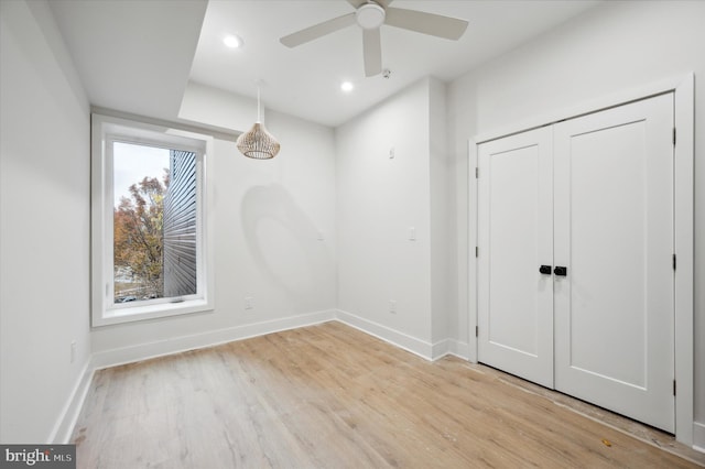 unfurnished room with ceiling fan and light hardwood / wood-style flooring