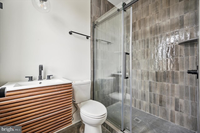 bathroom with toilet and a shower with shower door