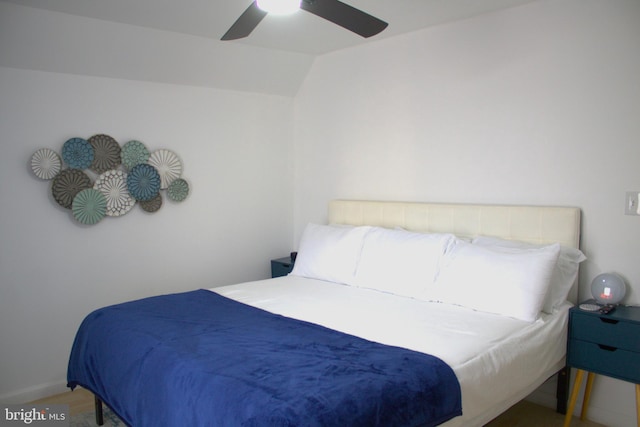 bedroom featuring ceiling fan, lofted ceiling, and hardwood / wood-style floors