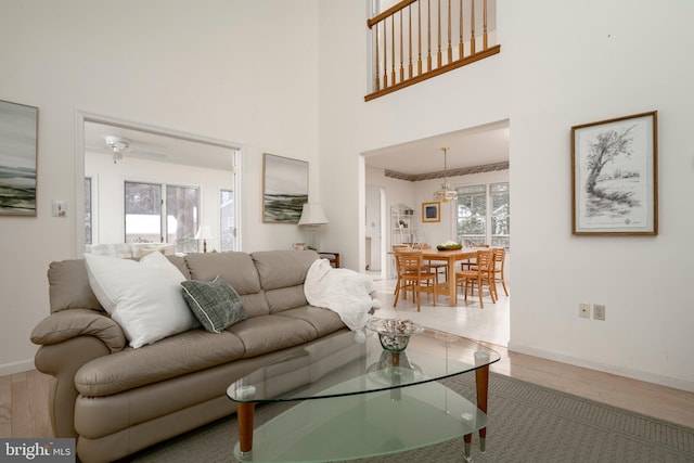 living room featuring wood-type flooring and a towering ceiling