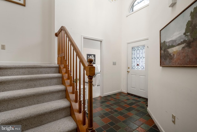 foyer entrance featuring a high ceiling and a wealth of natural light