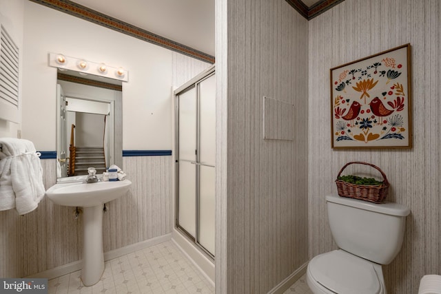 bathroom with a shower with shower door and toilet