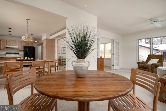 tiled dining area featuring ceiling fan