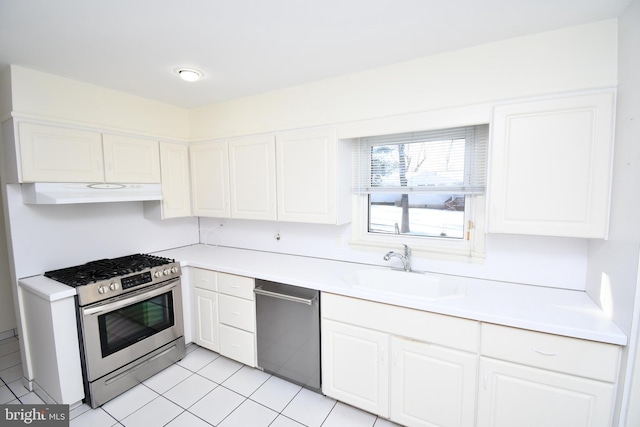 kitchen featuring white cabinetry, sink, light tile patterned floors, and stainless steel appliances