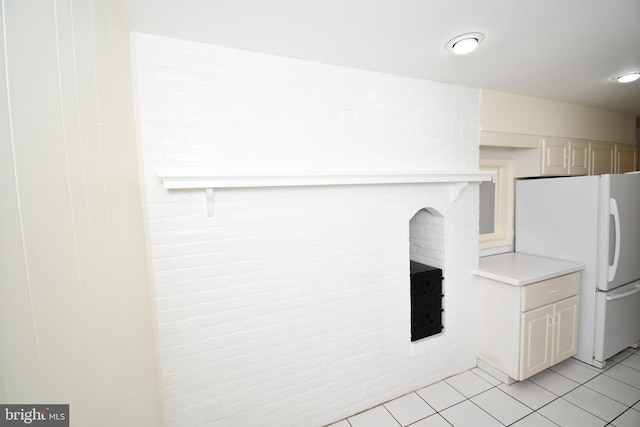 kitchen featuring light tile patterned floors and white refrigerator