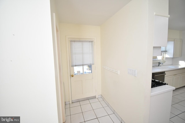 entryway featuring light tile patterned floors and sink