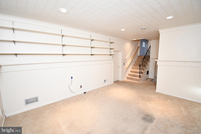 basement featuring crown molding and light carpet