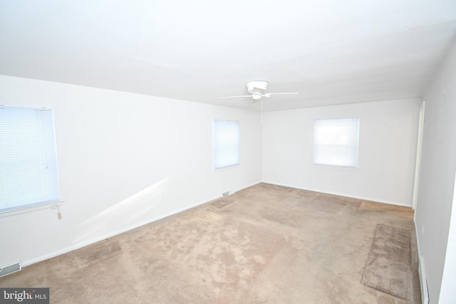 unfurnished room featuring light carpet and ceiling fan