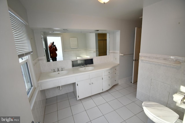 bathroom featuring tile patterned flooring, vanity, tile walls, and toilet