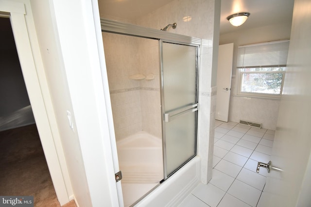 bathroom featuring bath / shower combo with glass door and tile patterned floors